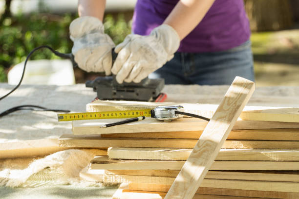 istock DIY - Home improvement; woman sanding wood plank 906583140