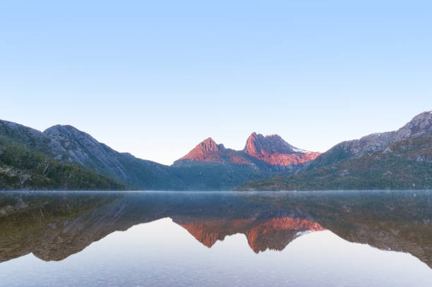 istock Mountain on sunrise reflected on mirror like lake water 906585946