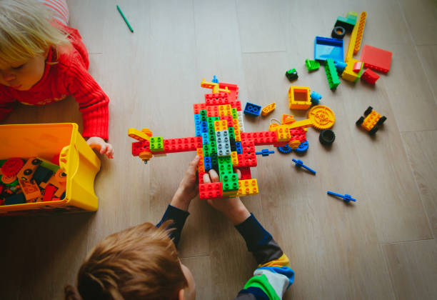 istock little boy and girl play with plastic blocks 906596640
