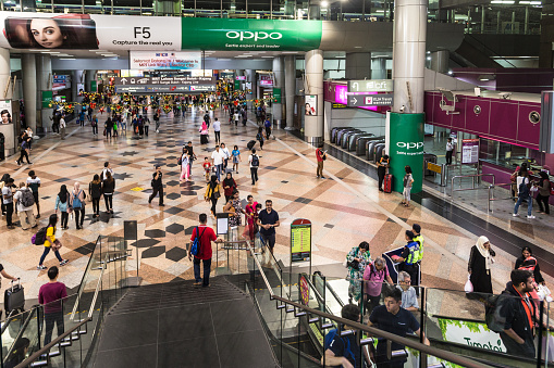 Kuala Lumpur, Malaysia - December 22, 2017: People walk through the Sentral train station in Kuala Lumpur in Malaysia. Sentral is the main station handeling both commuter and long distrance trains.