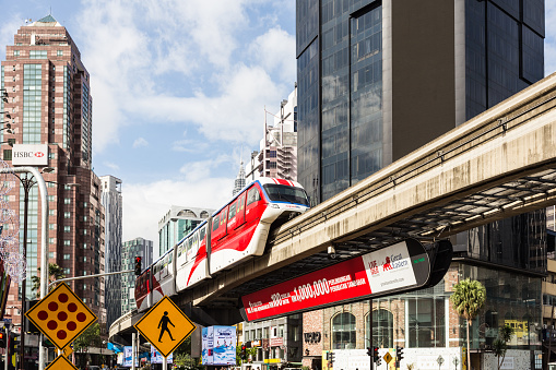 Kuala Lumpur, Malaysia - December 24, 2017: A monorail train rushes through the Bukit Bintang intersection in the Golden Triangle area in the heart of Kuala Lumpur in Malaysia capital city on a sunny day.