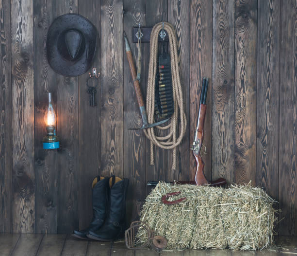istock old cowboy barn, weapons, clothing, hay 906605874