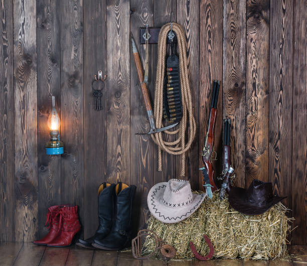 istock old cowboy barn, weapons, clothing, hay 906606224