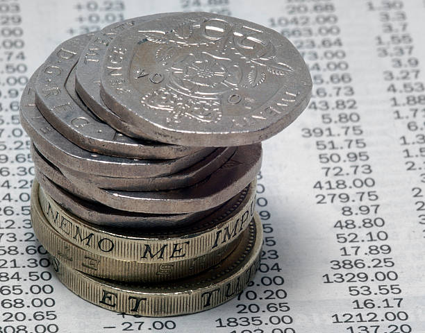 istock coins on newspaper stock prices 90660702