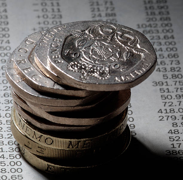 istock coins on newspaper stock prices 90660703