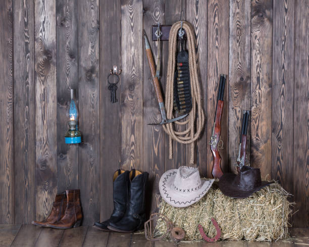 istock old cowboy barn, weapons, clothing, hay 906608534