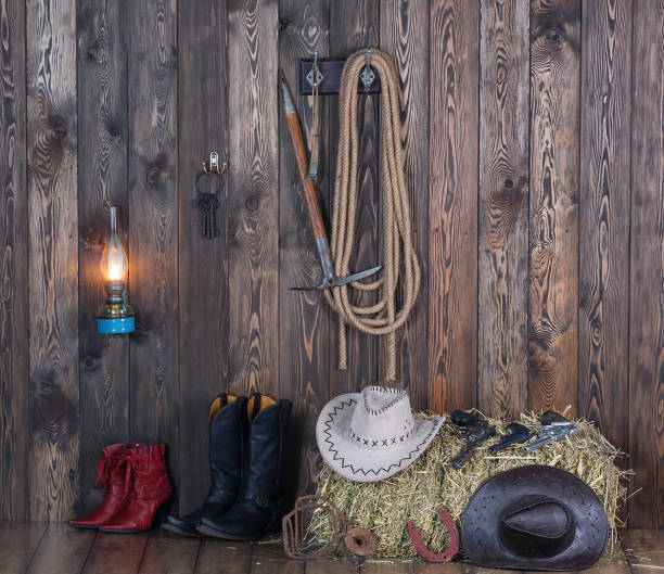 istock old cowboy barn, weapons, clothing, hay 906608544
