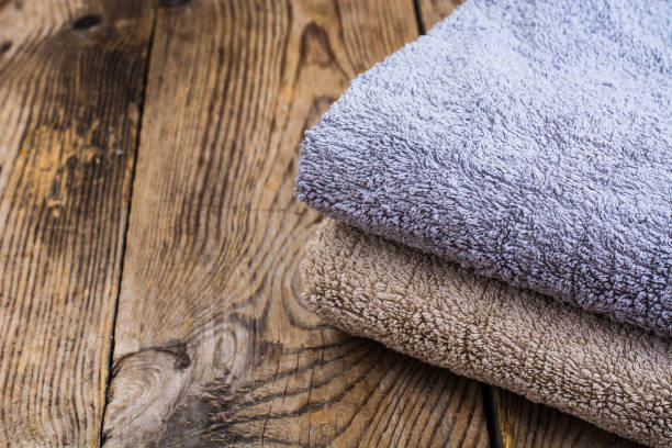 istock Stack of terry towels on wooden table 906608550