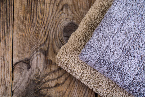 istock Stack of terry towels on wooden table 906608606
