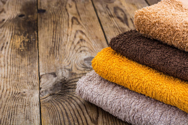 istock Stack of terry towels on wooden table 906608666