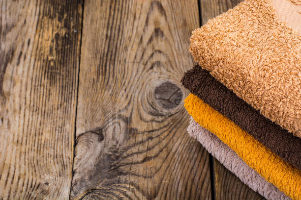 istock Stack of terry towels on wooden table 906608718