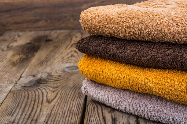 istock Stack of terry towels on wooden table 906608870
