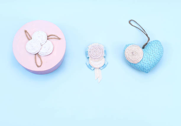 istock decorative gift box, textile heart on a blue background. 906611836