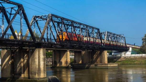 istock The train on the bridge runs across the river. 906614810