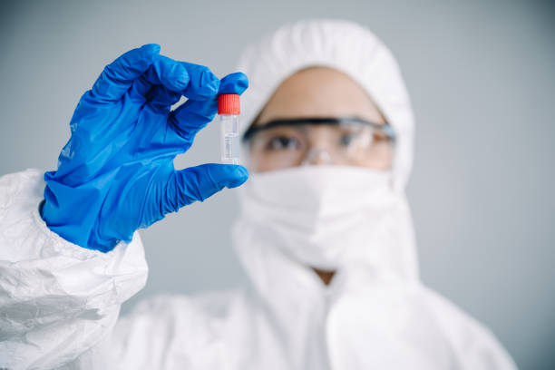 istock Asian female scientist looking at a test tube, studio shot 906614856
