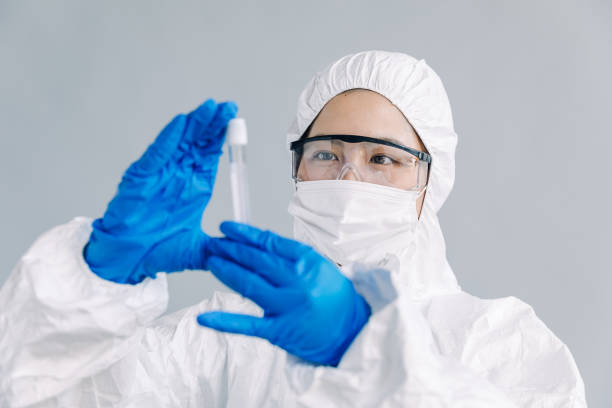 istock Asian female scientist looking at a test tube, studio shot 906614910