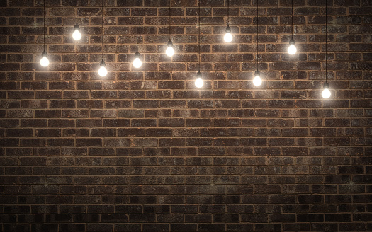 Shining light bulbs on dark brick wall. 3d rendering