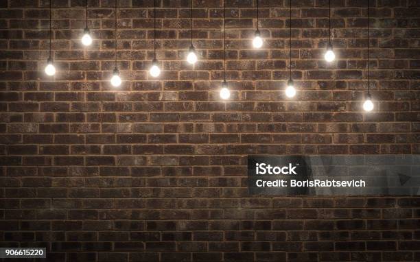 Shining Light Bulbs On Dark Brick Wall 3d Rendering Stock Photo - Download Image Now