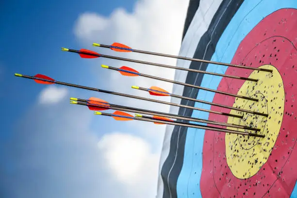 Target and arrows archery sport, outdoor with blue sky.