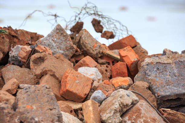 istock A pile of construction debris with broken bricks and concrete in winter against a background of snow. 906615578