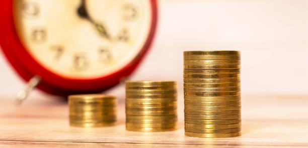 istock Time to savings - money coins with alarm clock 906618918