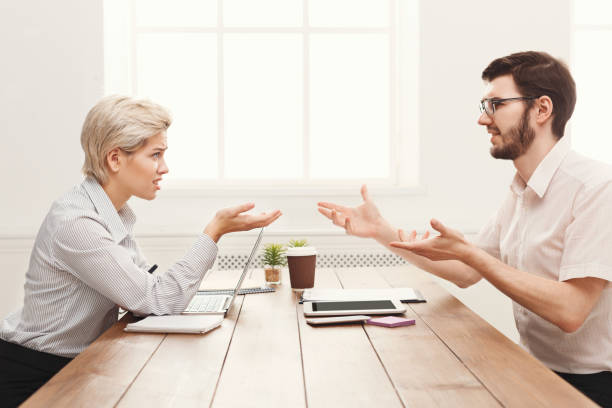 istock Couple of young colleagues working at modern office 906619112