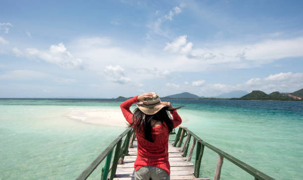 istock Young Woman Wear Red Shirt At Beach 906622012