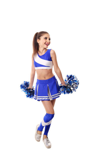 istock Young cheerleader in blue and white suit with pompoms on white background. Isolated on white background. 906626424