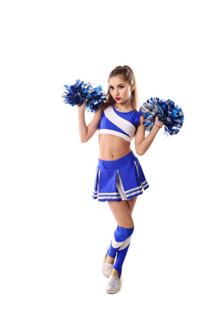 istock Young cheerleader in blue and white suit with pompoms on white background. Isolated on white background. 906626430