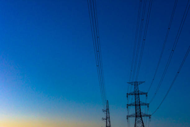 istock Electricity station. Close up high voltage power lines at sunset. 906629458