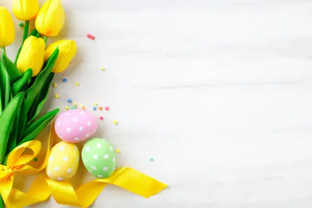 Photo of Happy Easter. Congratulatory easter background. Easter eggs and flowers