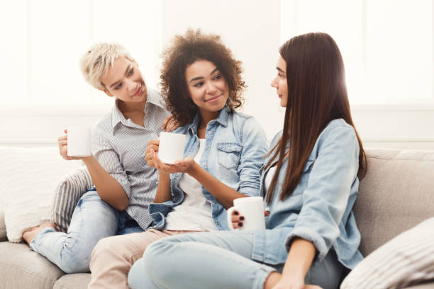 istock Three young female friends with coffee conversing 906641054