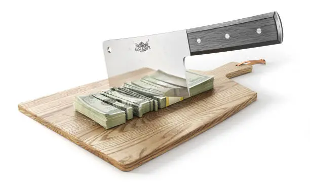 Photo of Money is chopped. Big knife cutting money stack on a wooden board. 3d illustration