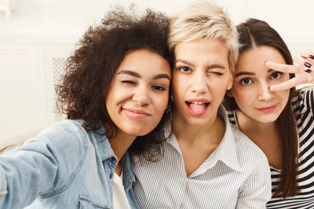 istock Happy friends taking selfie at home 906641922