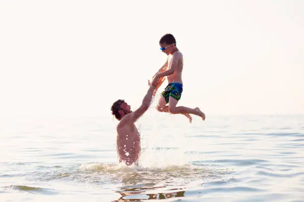 Father and son games in the sea.