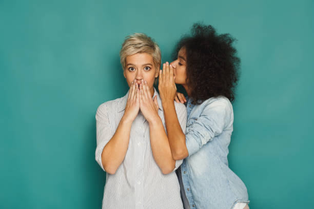 istock Young woman telling her friend some secrets 906644680