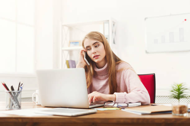 istock Serious business woman at work talking on phone 906645254