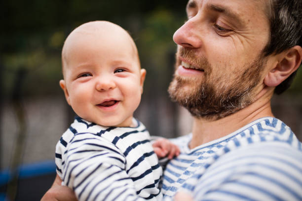 istock Father with little baby, summer day. 906647512