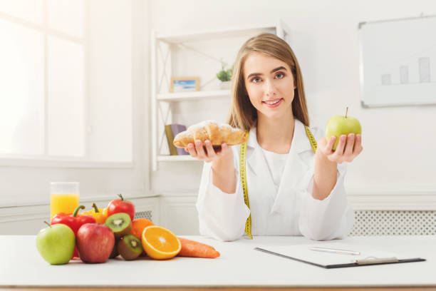 istock Dietitian nutritionist with bun and apple 906647760