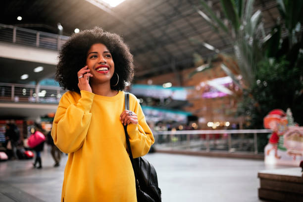 istock Beautiful afro woman using mobile in the train station. 906648026