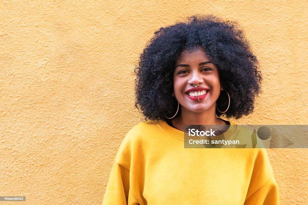 Portrait of beautiful afro american woman. Portrait of beautiful afro american woman in the street. Hipster Culture Stock Photo