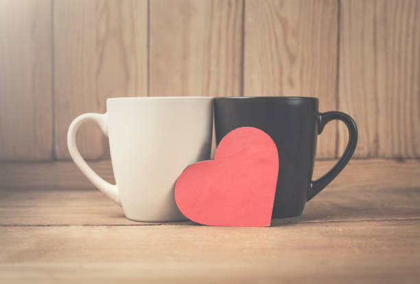 istock Coffee cups with red heart on a wood background. 906648864