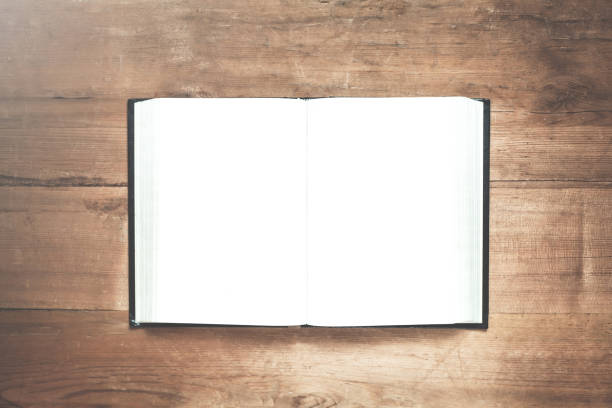 istock Opened book on the wooden background. 906648872