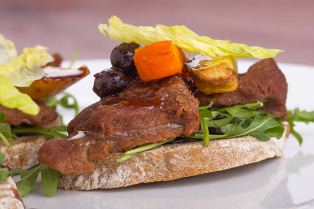 Roasted beef cheek on a toast. stock photo