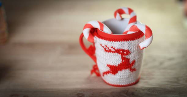 Christmas mug and candle on wooden background