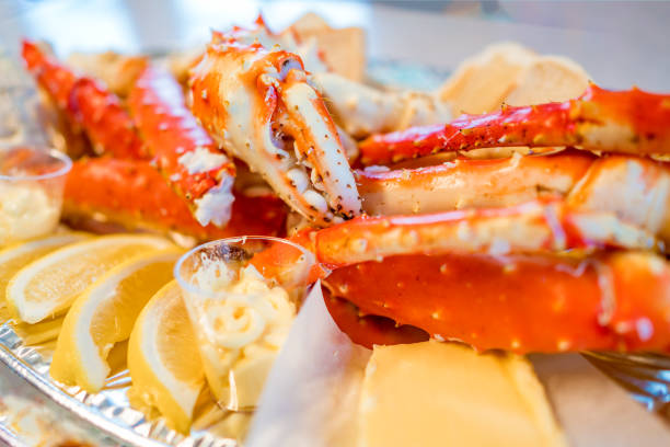 istock Red king crab legs with fresh lemon slices 906655740