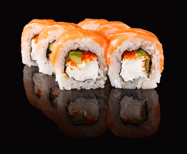 istock Japanese rolls on black mirroring background 906656044