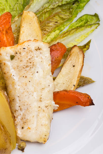 Cod fish with sauted vegetables. stock photo