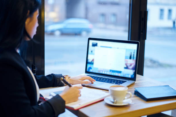 istock Professional business woman doing remote job using application for accountings on laptop computer with mock up screen, professional marketing expert  browsing information pondering on planning project 906661014