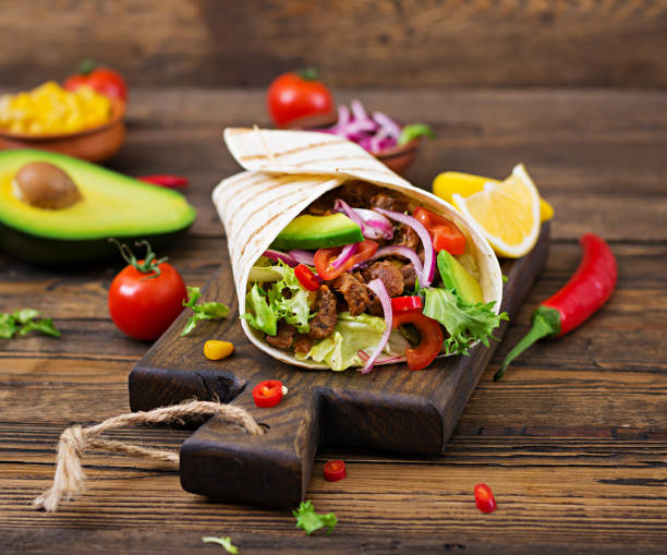 istock Mexican tacos with beef in tomato sauce and avocado salsa 906661072